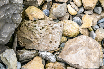 Stones with rock erosion holes at beach in Ireland