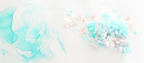Creative image of pastel blue and pink Hydrangea flowers on artistic ink background. Top view with copy space - obrazy, fototapety, plakaty