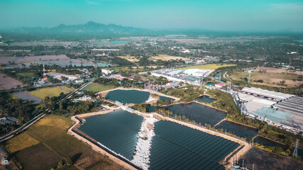 Fototapeta premium Aerial view of a solar farm producing clean energy during the evening. visible all around area