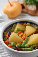 Bowl of delicious turnip soup on table, closeup view