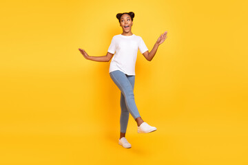 Fototapeta na wymiar Full body photo of young african woman have fun dance fooling wear casual clothes isolated over yellow color background