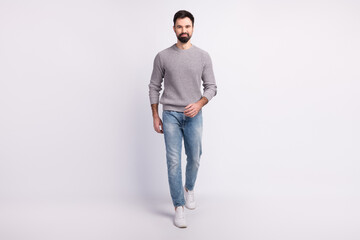 Full size photo of young guy confident go walk wear casual clothes isolated over grey color background