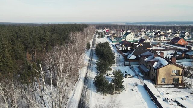 4K footage of a cottage village from a height. aerial in winter