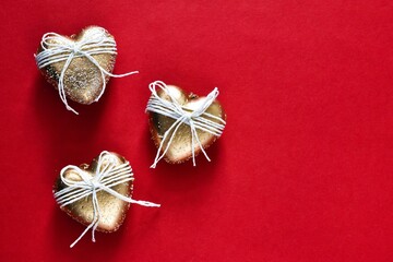 Valentine's Day concept with golden hearts on red background. Copy space, flat lay. Banner....