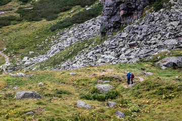 Fototapeta premium An elderly couple hiking up the mountains near Kaprun