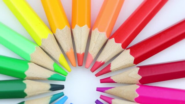Bright colorful pencils rotating around
