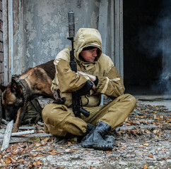 An armed soldier and a Belgian shepherd dog. Belgian Shepherd Dog in the army. Police dog for special operations.