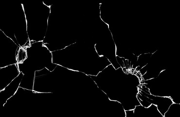 Texture with cracks and holes in the window glass from breaking, abstraction on a black background.