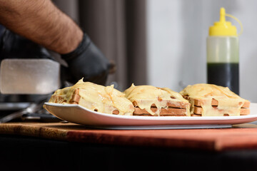 Francesinha, traditional Portuguese sandwich originally from Porto. National cuisine concept. the chef prepares a dish at restaurant