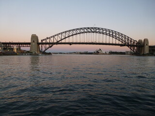 Fototapeta na wymiar Sydney Harbour Bridge with the Opera House in the background seen from the west side at dusk, Sydney, New South Wales, Australia