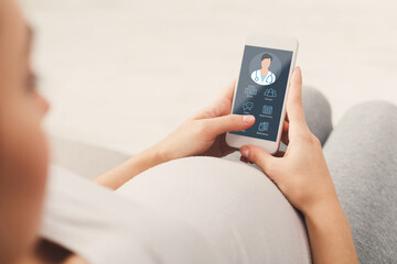 Pregnant lady using online medical service on mobile phone