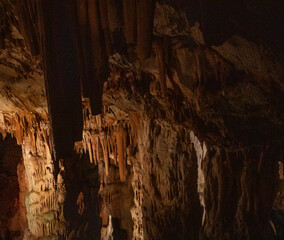 fabulous abstract background of stalactites, stalagmites and stalagnates in a cave underground, horizonta