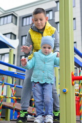Boy and girl playing in the playground