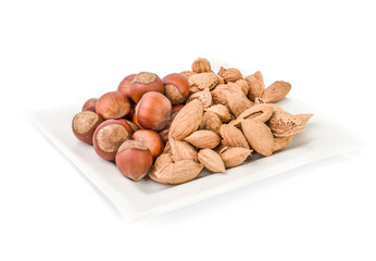 Mixed nuts and dry fruits in plate isolated on Hazelnut and Walnut mix almond on white plate