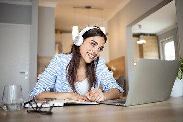 Woman talking to colleagues via video call from home