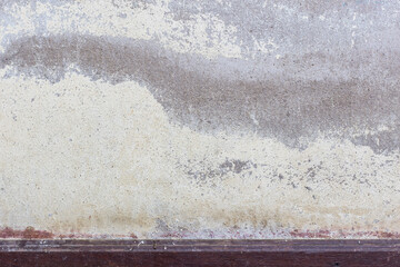 An old white wall building has drying mark of water or moist as yellow mark and cracks.
