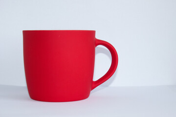 Blank red mug isolated on white background,mat tea or coffee cup,mock up with ceramic mug for hot drinks,empty gift print branding template,tankard for design,placement for logo.