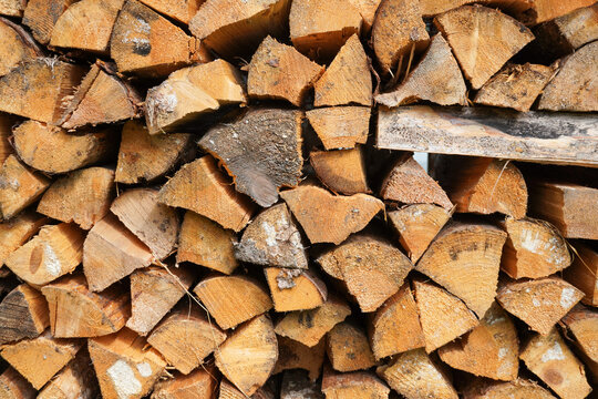 Lots of firebox logs stacked firewood wooden blocks. texture background pattern High quality photo