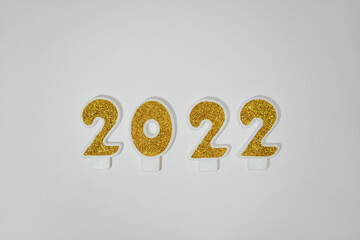 Happy New 2022 Year. 2022 golden numbers on white background 