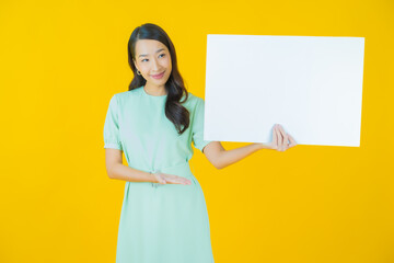 Portrait beautiful young asian woman with empty white billboard