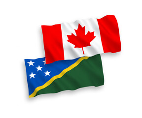 National vector fabric wave flags of Canada and Solomon Islands isolated on white background. 1 to 2 proportion.