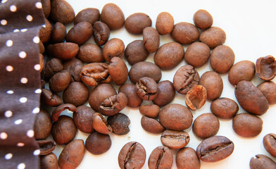 Brown natural Coffee Beans in Bag on white background Close up