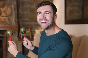 Man playing the maracas at home
