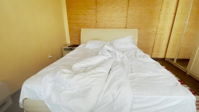 unmade bed bedroom house. bed a early morning bed sheet. white linens in the hotel. unmade bed early morning in bedroom house lifestyle