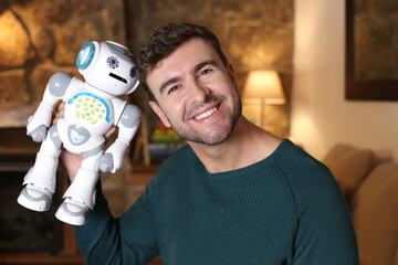 Man holding futuristic robot at home
