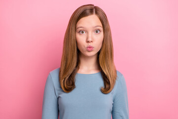 Portrait of attractive funny brown-haired girl sending air kiss feelings isolated over pink pastel...
