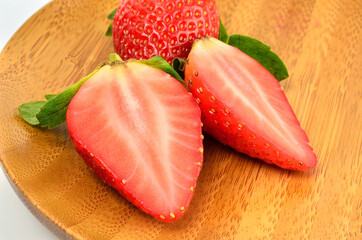 Fresh strawberry on a wooden plate