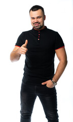 portrait of a man in a black t-shirt and jeans in the studio. pumped up Italian macho. isolated white background