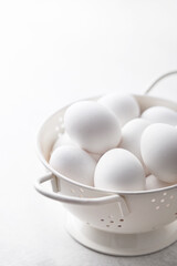 Eggs in a bowl. White eggs viewed from above. Top view. Copy space
