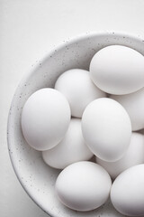 Eggs in a bowl. White eggs viewed from above. Top view