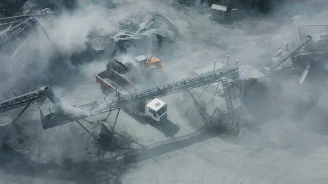 Granite mining by open-pit method. The video shows loading. The loader loads the mass into a dump truck.