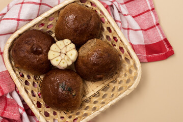 Traditional Ukrainian Homemade Garlic Buns Pampushki with Oil and Coriander Yellow Background Horizontal