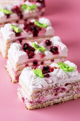 Pieces of Tasty Homemade Biscuit Cake on Pink Background Tasty Dessert with Cream Vertical