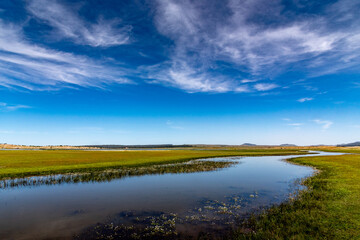 Lake Afnourir in Morocco. The sky is reflected in the still waters of a swampy area of the lake