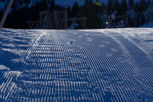 Close-up of pattern in the snow after reparation of slope by snowcat at mountain village Stoos, Canton Schwyz, on a sunny winter day. Photo taken December 20th, 2021, Stoos, Switzerland.