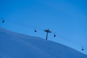 Chair lift at mountain Klingenstock on a sunny winter day with blue sky background. Photo taken December 20st, 2021, Stoos, Switzerland.