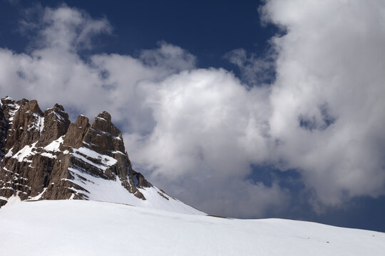 Rock and snow pass in clouds