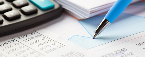 Accounting document with pen,color diagram and checking financial chart. Concept of banking, financial report and financial audit. In blue color.