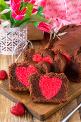 St. Valentine's Day, Birthday or Mother's Day dessert, homemade festive food. Homemade sweet chocolate brownie cake with red heart on a wooden rustic tabletop.