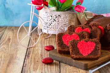 St. Valentine's Day, Birthday or Mother's Day dessert, homemade festive food. Homemade sweet chocolate brownie cake with red heart on a wooden rustic tabletop. Copy space.