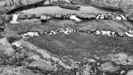 Nature at Fossatun Troll Falls, Iceland, Europe. Beautiful green landscape with a mountain view in summer season from drone viewpoint