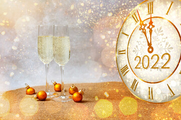 New year 2022 celebration, countdown and date. Bright abstract background with glasses of champagne and fireworks