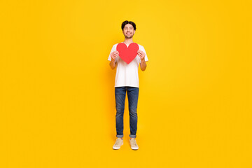 Full size photo of cool young guy show okey wear white t-shirt jeans isolated on yellow color background