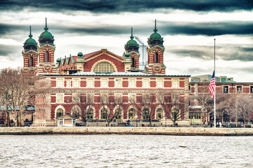 Ellis Island building exterior, view from moving boat in New Yor