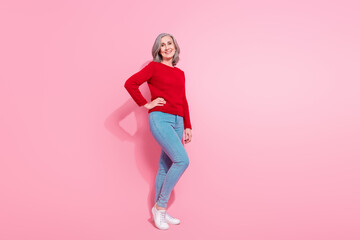 Full length body size view of attractive cheerful grey-haired middle-aged woman posing isolated over pink pastel color background