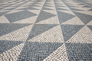 cobblestone pavement in grey tones, with triangular pattern